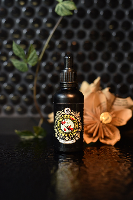 Rose geranium and rosehip face serum in a black dropper bottle