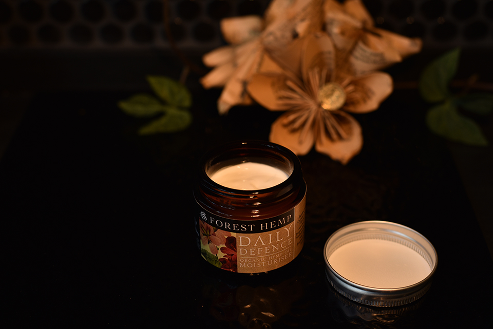 Daily Defence organic hemp oil moisturiser, an open amber jar