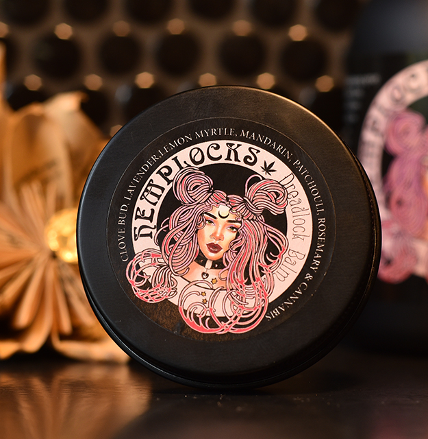 Hemplocks dreadlock balm in a black tin with an illustrated label